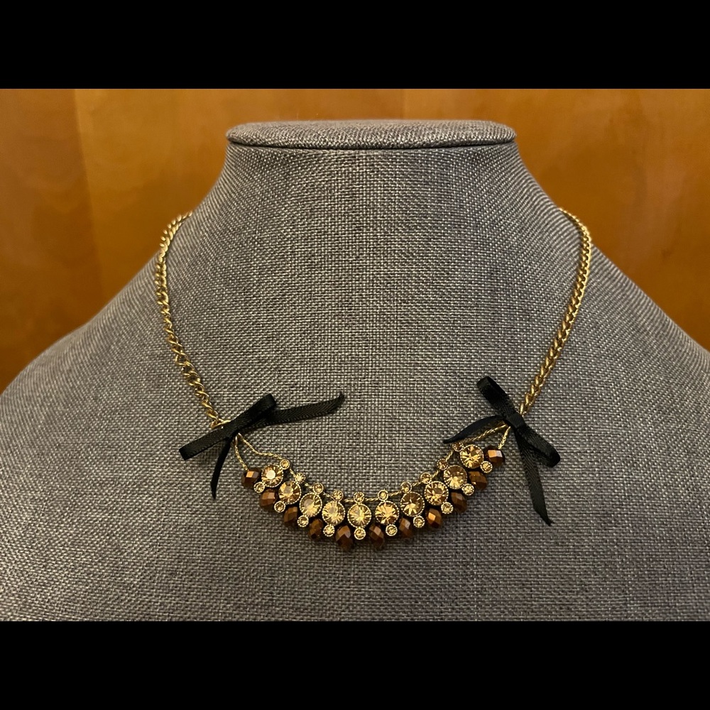Betsey Johnson gold-tone necklace with glittery beads, rhinestones, and bows